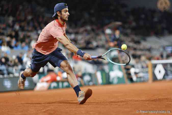 Novak Djokovic keeps his French Open title defense going by getting past Lorenzo Musetti in 5 sets