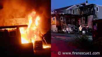 2 rescued from roof of burning Mass. house