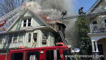 Mayday: Boston firefighter briefly trapped on roof of burning house