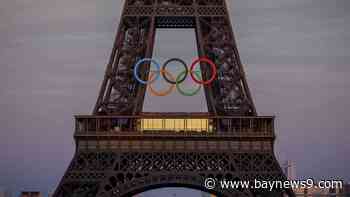 The Olympic rings are mounted on the Eiffel Tower to mark 50 days until the Paris Games