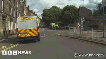 Man, 43, charged after body found in city flat