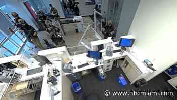 Video shows man killed by sniper while holding two people hostage in Florida bank