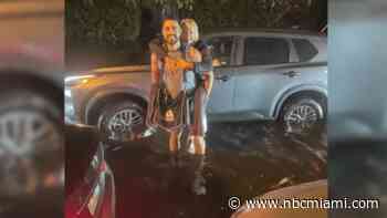 ‘A hero': Story behind photo of stranger saving woman stranded in South Florida floodwaters
