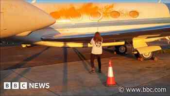 Pair held after orange paint sprayed on aircraft