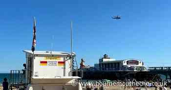 Emergency helicopter hovering over Bournemouth beach
