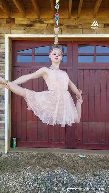 Watch in awe as she dances effortlessly while hanging by her hair!