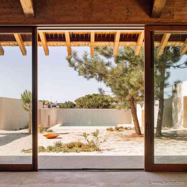SIA Arquitectura uses lime render and wood to "echo the sandy landscape" surrounding coastal home
