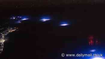 Mysterious red lights glowing in Earth's atmosphere are captured by astronauts in space