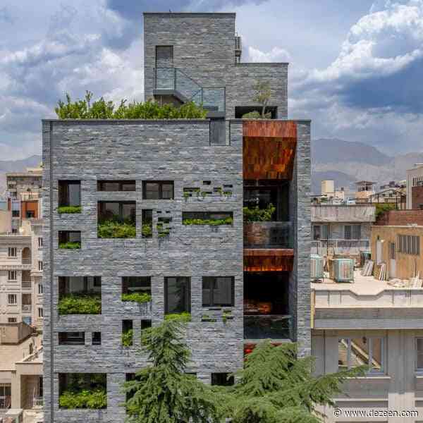 Glazed copper-coloured bricks reflect light into Tehran apartment block by Hooba Design Group