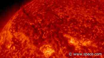 Watch two plumes of 'dark' plasma explode from the sun and send solar storm towards Earth (video)