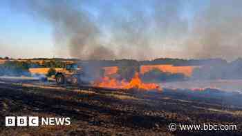 Farmers help firefighters tackle hay blaze in field