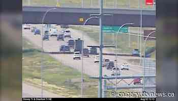 Wheel falls off trailer on Stoney Trail, striking windshield