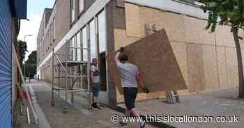 Pictures show North Finchley shops boarded up and police preparing for riot