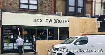 Shop windows boarded up in case of riot as people warned to keep away