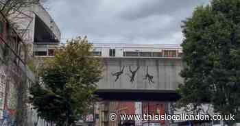 Three monkeys artwork by Banksy appears on railway bridge