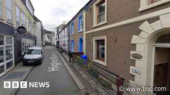 Crews fight bin fire that spread to building
