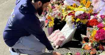 Volunteers hand out roses at funeral of stabbing victim