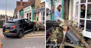 Car smashes into High Street cafe after swerving 'near miss'