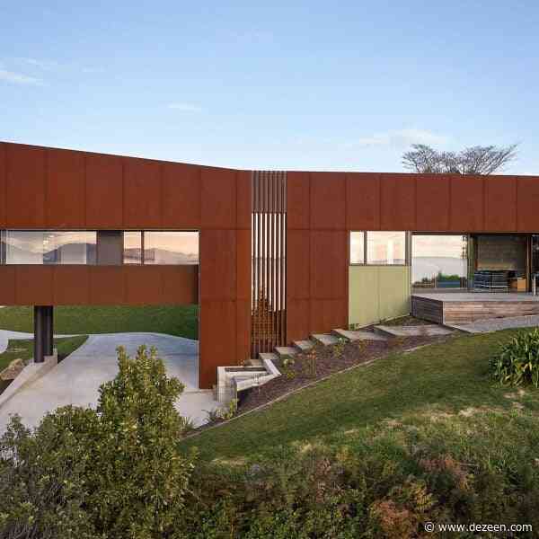 Parsonson Architects perches stilted red home on coast of New Zealand
