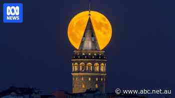 Photographers capture rare 'blue' supermoon as it lights up global landmarks