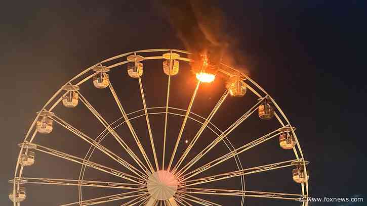 Sky-high horror caught on video as Ferris wheel catches fire during music festival