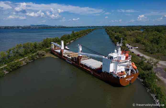 Tugboats free grounded cargo ship blocking traffic in St. Lawrence Seaway