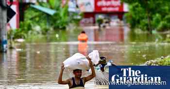 Bangladeshis taking refuge in emergency shelters after heavy flooding