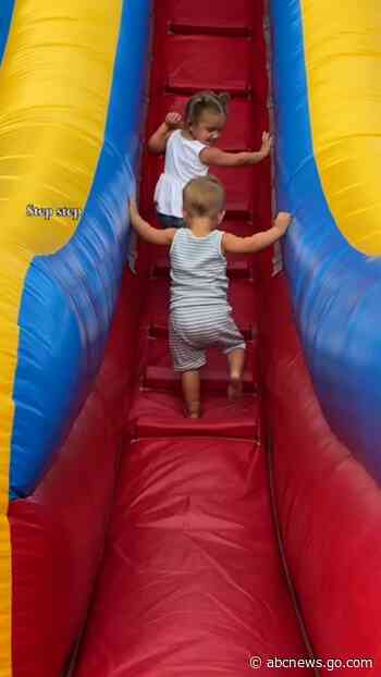 WATCH:  Sister cheers on little brother, shows him how to go down slide