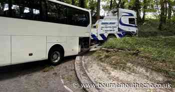 Coach full of holidaymakers becomes wedged on road