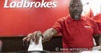 Ex-Liverpool star John Barnes spotted working in local bookies