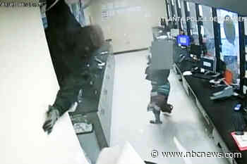 Video shows robbers drop into check cashing store from ceiling in $150,000 heist
