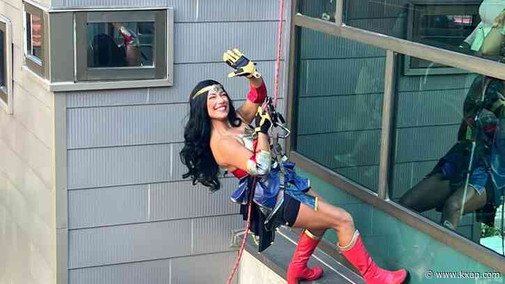 Superheroes rappel down Dell Children's building, giving patients a show