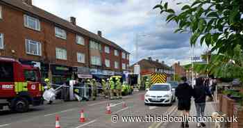 Car flips onto its side and partly blocks road