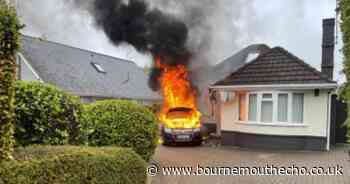 Multiple firefighters extinguish blazing vehicle fire