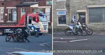Yobs spotted pulling motorbike from the back of moving truck