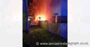 Garage fire spreads to rear of house and vehicles