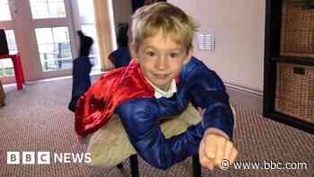Six-year-old superhero walking in dad's memory