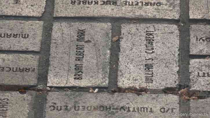 People removing their bricks along Olympic Plaza pathway ahead of revamp