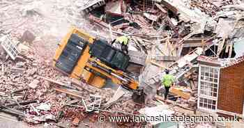 WATCH: The moment a digger tips over while demolishing building