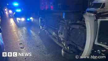 Road closed after car flips over in collision