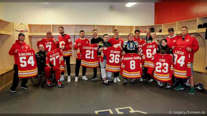 Calgary Flames present team jerseys to sledge hockey players heading to NHL Sled Hockey Classic in Dallas