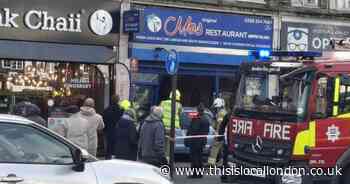 Man in hospital after car crashes into restaurant on busy Kingsbury road