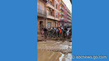 WATCH:  Volunteers sweep out water after deadly Spain floods