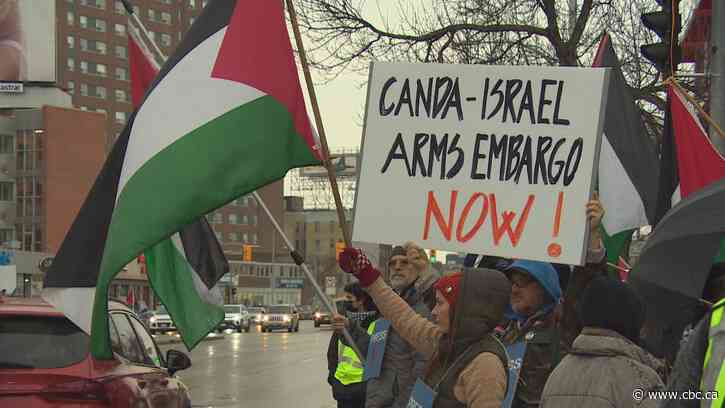 People rally in solidarity with Palestinians in front of CBC Manitoba building
