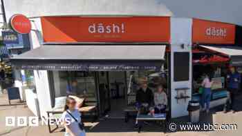 Cafe ordered to take down bright orange signs