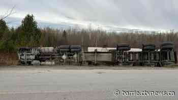 Gravel truck driver charged after rollover collision