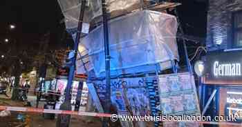 Pictures show scaffolding teetering over pavement amid storm winds