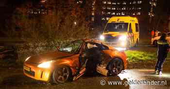Sportauto breekt bijna in tweeën door klap tegen boom in Arnhem, man met spoed naar ziekenhuis