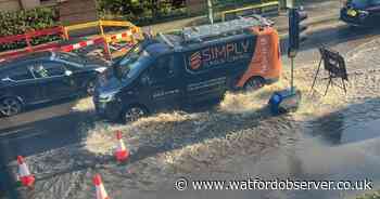 Burst pipe turns road into 'lake' with water 'lapping against homes'