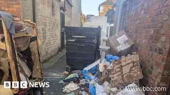 'We have to climb over rubbish outside our homes'